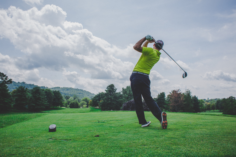 a man after hitting a golf ball from a tee